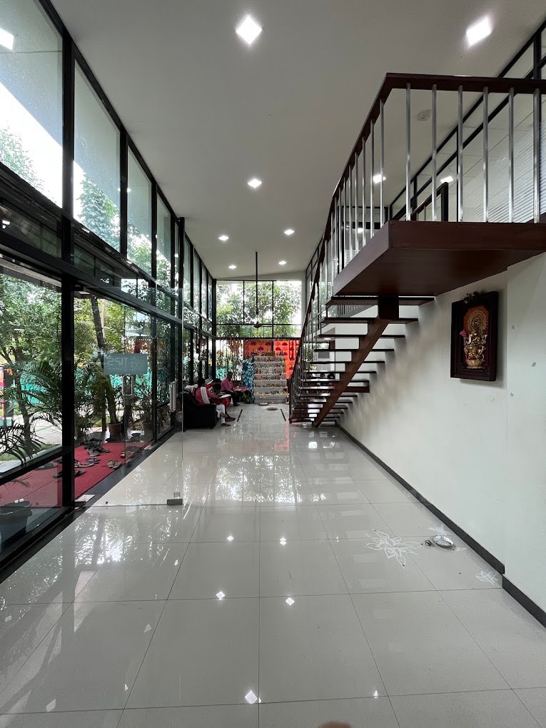 Modern institutional interior with floating staircase and glass walls