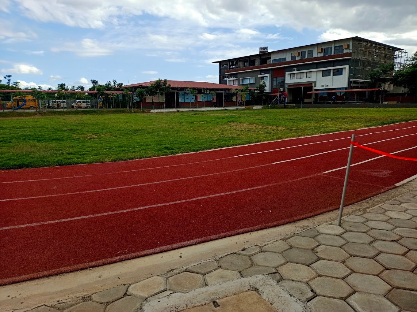 School running track with campus building in background